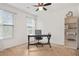 Bright bedroom features two windows, neutral carpet, ceiling fan and space for a desk and shelving at 2521 Capella Sw Cir, Atlanta, GA 30331