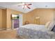 Primary bedroom features a lighted ceiling fan, TV on top of the dresser, and an ensuite bathroom at 2521 Capella Sw Cir, Atlanta, GA 30331