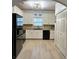 Well-lit kitchen featuring white cabinets, modern appliances, and neutral countertops at 2521 Capella Sw Cir, Atlanta, GA 30331