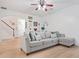 Bright living room with decorative wall art, modern ceiling fan, and comfortable sectional sofa at 2521 Capella Sw Cir, Atlanta, GA 30331