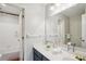 Bathroom featuring a double sink vanity, large mirror, and a shower/tub combo at 2615 Springmonte Pl, Cumming, GA 30041