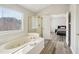 Bright bathroom showcasing a soaking tub with a window and glass enclosed shower at 2615 Springmonte Pl, Cumming, GA 30041