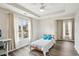 Sunlit bedroom featuring hardwood floors, tray ceilings, and large windows at 2615 Springmonte Pl, Cumming, GA 30041