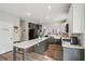 A modern kitchen features an island with a stone countertop, stainless steel appliances, and a convenient pantry at 2615 Springmonte Pl, Cumming, GA 30041