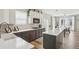 A kitchen showcasing an island with white countertops and ample cabinet space and a breakfast nook in a well-lit setting at 2615 Springmonte Pl, Cumming, GA 30041
