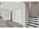 Open-concept living room featuring updated flooring, staircase to upper level, and abundant natural light at 2615 Springmonte Pl, Cumming, GA 30041