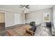 Spacious living room showcasing updated flooring, a ceiling fan, natural light, and a view of the stairs at 2615 Springmonte Pl, Cumming, GA 30041
