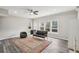 Bright living room featuring a ceiling fan, large windows, updated flooring, and ample space at 2615 Springmonte Pl, Cumming, GA 30041