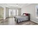 Spacious bedroom with tray ceilings, a ceiling fan, and a large window for natural light at 2615 Springmonte Pl, Cumming, GA 30041