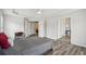 Bedroom featuring wood floors, tray ceilings, and multiple doorways at 2615 Springmonte Pl, Cumming, GA 30041