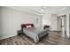 Bedroom with tray ceilings, wood floors, and a dark gray night stand at 2615 Springmonte Pl, Cumming, GA 30041