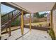 Covered patio area with stairs leading to upper level deck at 2615 Springmonte Pl, Cumming, GA 30041