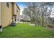 Backyard with a lush green lawn, patio, shade trees, and yellow house exterior at 4831 Lake Park Ter, Acworth, GA 30101