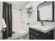 This bathroom features a shower and tub combination, tile backsplash and stylish single sink vanity at 4831 Lake Park Ter, Acworth, GA 30101