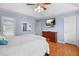 Bright bedroom showcases wood floors, a mounted TV, and ample closet space at 4831 Lake Park Ter, Acworth, GA 30101