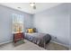 Cozy room with a window, bedside table, and carpet at 4831 Lake Park Ter, Acworth, GA 30101