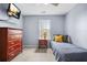 Bedroom featuring a bed, wooden drawers, window, and mounted TV at 4831 Lake Park Ter, Acworth, GA 30101