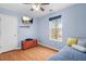 Bedroom has hardwood floors, a mounted TV, a ceiling fan, and natural light at 4831 Lake Park Ter, Acworth, GA 30101