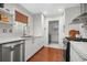 Bright kitchen with stainless steel appliances, white cabinets and countertops, and wood flooring at 4831 Lake Park Ter, Acworth, GA 30101