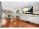 Bright living room featuring a decorative fireplace, hardwood floors, and modern entertainment center at 4831 Lake Park Ter, Acworth, GA 30101