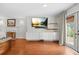 Bright living room featuring a decorative fireplace, hardwood floors, and access to a patio at 4831 Lake Park Ter, Acworth, GA 30101