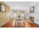 Bright living room featuring a decorative fireplace, hardwood floors, and modern entertainment center at 4831 Lake Park Ter, Acworth, GA 30101