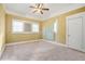 Bedroom featuring carpeted floors, a ceiling fan, and natural light from the windows at 732 Cascade Ave, Atlanta, GA 30310