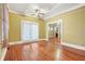 The living room features hardwood floors, a ceiling fan, and large windows that let in plenty of natural light at 732 Cascade Ave, Atlanta, GA 30310