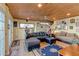 Living room with sofa, love seat, wood paneled ceilings, and door to porch at 5 Yachting Way, Acworth, GA 30102