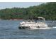 A large party boat cruising along the lake with forest views along the bank at 5 Yachting Way, Acworth, GA 30102