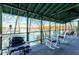 Enjoy lake views from this screened porch with rocking chairs and grill at 5 Yachting Way, Acworth, GA 30102