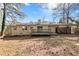 View of the backyard with a wooden deck and covered area perfect for outdoor relaxation and entertainment at 508 Greenridge Cir, Stone Mountain, GA 30083
