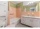 Retro-style bathroom with pink tile, checkered floors, and a white vanity at 508 Greenridge Cir, Stone Mountain, GA 30083