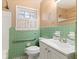 Bathroom with green tile, a white vanity, and a window at 508 Greenridge Cir, Stone Mountain, GA 30083