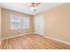 A bright bedroom with hardwood floors, a ceiling fan, and a double-door closet at 508 Greenridge Cir, Stone Mountain, GA 30083