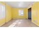 Bright bedroom with yellow walls, window with shutters, and door leading to ensuite bathroom at 508 Greenridge Cir, Stone Mountain, GA 30083
