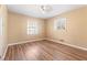 Bedroom featuring wood floors, tan walls, and two windows at 508 Greenridge Cir, Stone Mountain, GA 30083