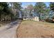 Charming single-Gathering home featuring a long driveway and covered parking, nestled amongst mature trees at 508 Greenridge Cir, Stone Mountain, GA 30083
