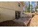 Exterior view of the home's brick facade with a walk-out basement and small patio area at 508 Greenridge Cir, Stone Mountain, GA 30083