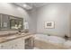 Bright bathroom with a large tub and a separate vanity with granite countertops, creating a spa-like atmosphere at 612 Vinings Estates Se Dr # B12, Smyrna, GA 30126