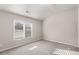 A carpeted bedroom with a large window letting in natural light from outside at 612 Vinings Estates Se Dr # B12, Smyrna, GA 30126