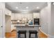 Well-lit kitchen boasts white cabinets, a stylish backsplash, stainless steel appliances, and hardwood floors at 612 Vinings Estates Se Dr # B12, Smyrna, GA 30126