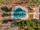 Aerial view of a covered community pool, a beautiful clubhouse, and green landscaping at 612 Vinings Estates Se Dr # B12, Smyrna, GA 30126