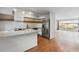 Open kitchen layout with stainless appliances, island, and seamlessly connected to living area at 1235 Woodland Ne Ave # 1, Atlanta, GA 30324