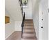 Stairwell featuring carpeted steps, black railing and a white door to unit 1 at 1235 Woodland Ne Ave # 1, Atlanta, GA 30324