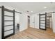 Bright bedroom with wood floors and access to an ensuite bathroom and closet through sliding barn doors at 1355 Lockwood Sw Dr, Atlanta, GA 30311