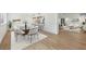 Staged dining area features a glass-top table with seating for ten and a view into the stylish living room at 1355 Lockwood Sw Dr, Atlanta, GA 30311