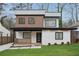 Charming two-story home featuring a modern design with a white brick facade and beautiful landscaping at 1355 Lockwood Sw Dr, Atlanta, GA 30311