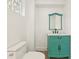 Charming powder room with a marble-top vanity, custom mirror, and vintage-style faucet and cabinet hardware at 1355 Lockwood Sw Dr, Atlanta, GA 30311