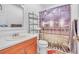 A clean bathroom featuring wood cabinets and a novelty stadium shower curtain at 20 Juniper Se Ln, Cartersville, GA 30121